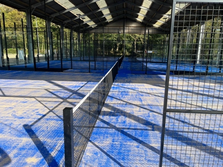 Op deze foto kijk je door de padelbaan heen naar de andere padelbanen. De laatste padelbaan is de Single padelbaan. Tevens zie je het verhoogde dak. 